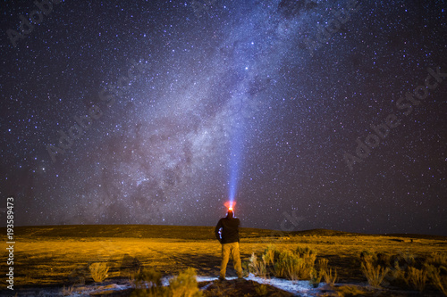 Man looking up at the Milky Way Galaxy in Potosi Department of Bolivia's Altiplano region photo
