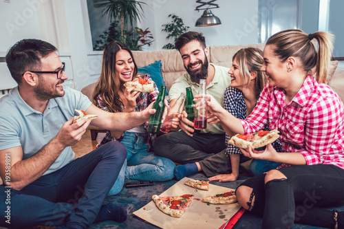 Group of young friends eating pizza.Home party.Fast food concept. © Mediteraneo