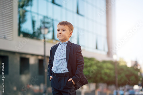 Boy in classic modern dark blue business costume  photo