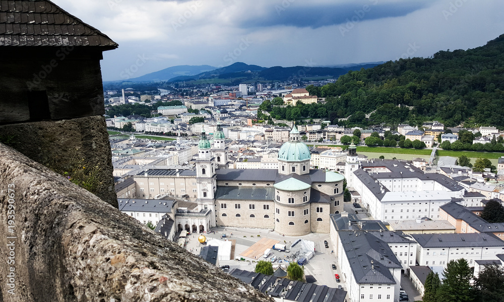 Obraz premium A view of the city of Salzburg, Austrai with dark stormy clouds approaching