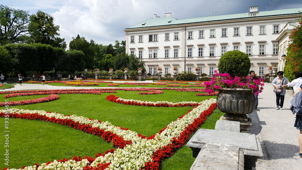 Fototapeta premium Mirabellgarten gardens in Mozartplatz in Salzburg, Austria with people