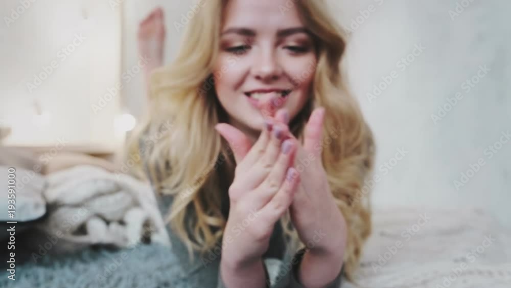 in the morning of the weekend, holiday young girl caring for the body. beautiful blonde cute smiling in bed in beautiful bedroom. in the morning of the weekend, holiday young girl caring for the body. beautiful blonde cute smiling in bed in beautiful bedroom.