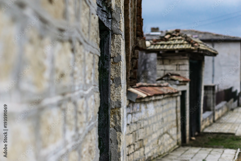 Close-up of an old rural house on a cold winter day. Buildings of the early 20th century with hulking windows and old cement screed. Shallow depth of focus. Close-up of an old rural house on a cold winter day. Buildings of the early 20th century with hulking windows and old cement screed. Shallow depth of focus.