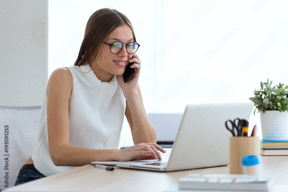 Portrait of business young woman using her mobile phone in the office. Portrait of business young woman using her mobile phone in the office.