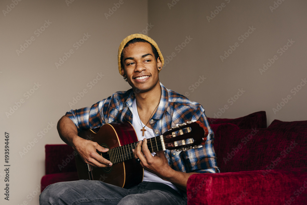 Cheerful ethnic man with guitar Cheerful ethnic man with guitar