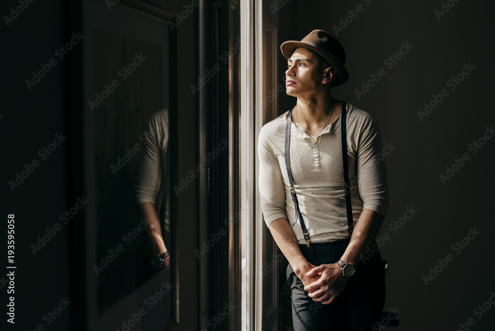 Dreamy Asian man at window Dreamy Asian man at window
