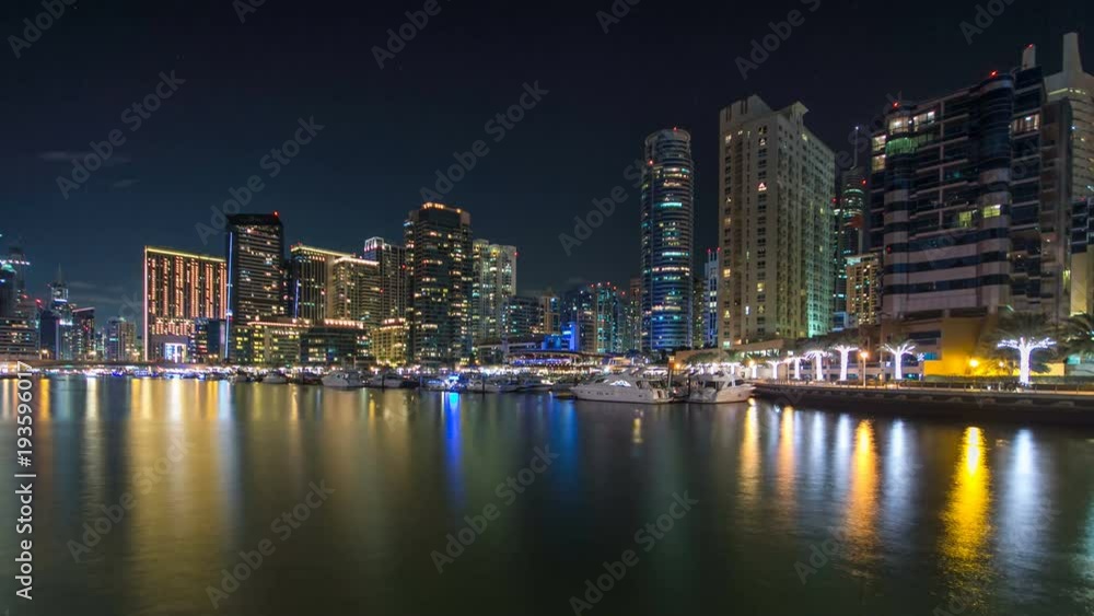 View of Dubai Marina Towers reflected in water of canal in Dubai day to night timelapse View of Dubai Marina Towers reflected in water of canal in Dubai day to night timelapse