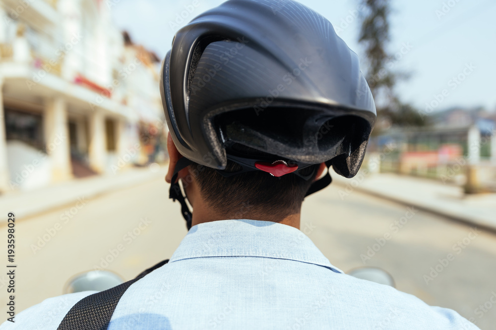 Back of the man wearing safety helmet while riding motorcycle in Sa Pa, Vietnam. Stock Photo