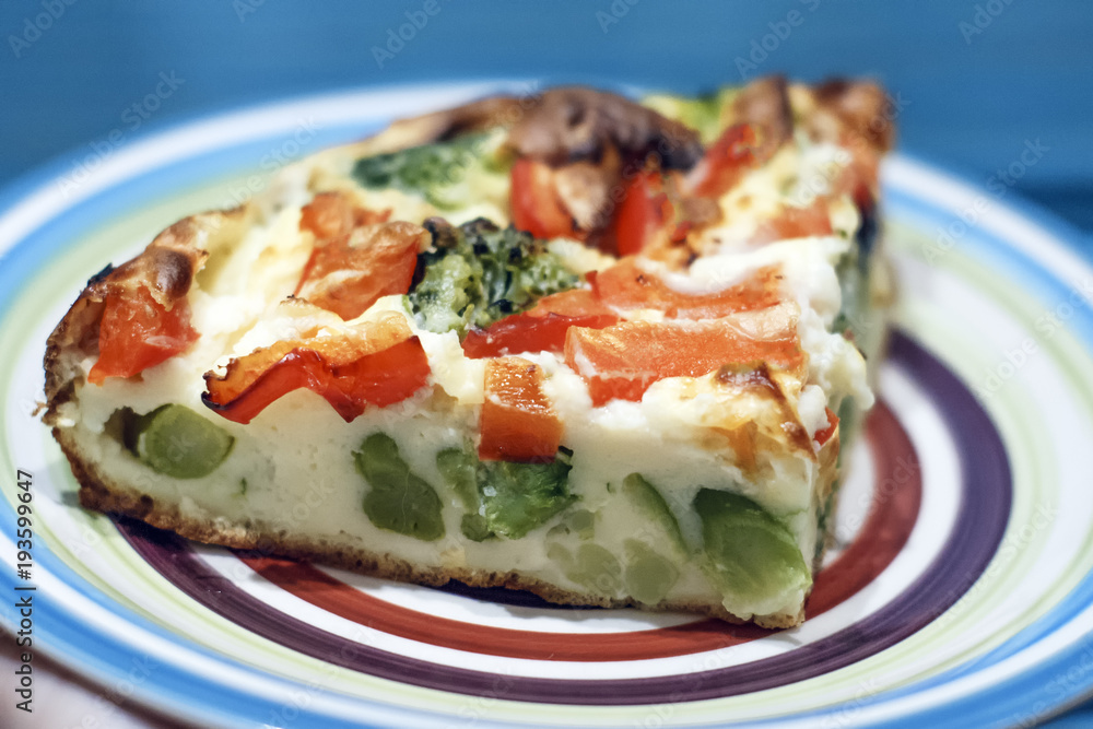 Slice of light Greek vegetable pie with cheese, broccoli and red pepper