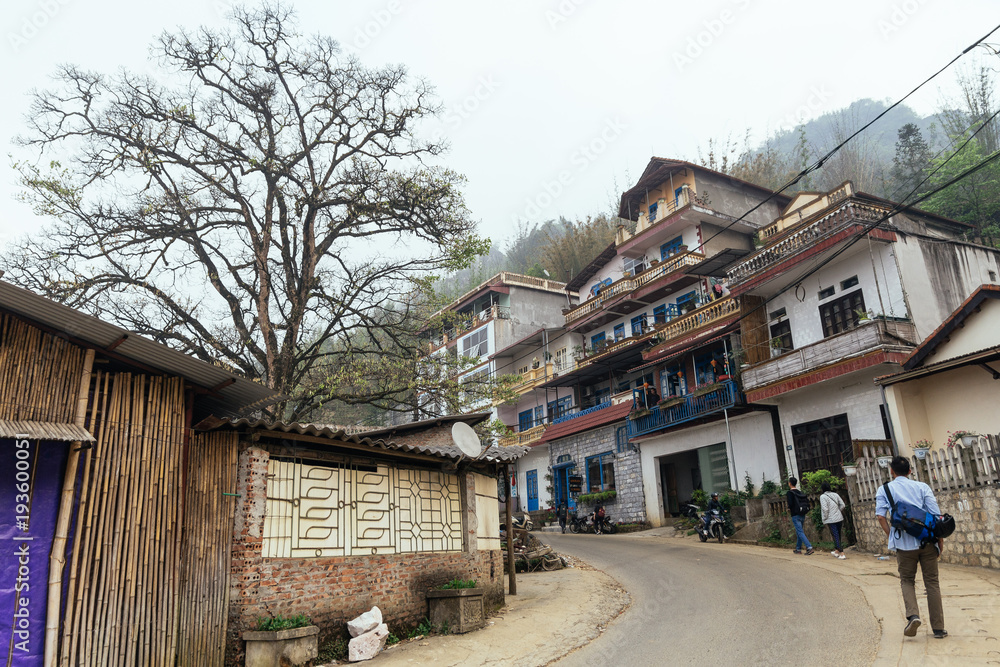 Houses on the hill and trees with tourist walking on the main road of the city in summer Sa Pa, Vietnam. Houses on the hill and trees with tourist walking on the main road of the city in summer Sa Pa, Vietnam.