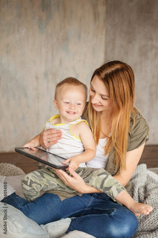 Cheerful Family. Mummy and Child Having Fun with Digital Tablet Cheerful Family. Mummy and Child Having Fun with Digital Tablet