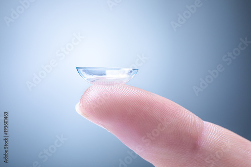 Fototapeta Naklejka Na Ścianę i Meble -  Contact Lens on a Man's Index Finger
