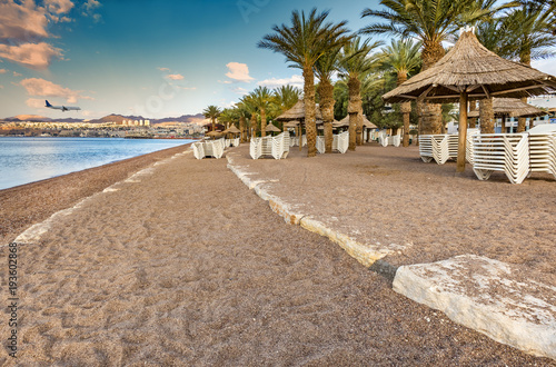 Morning on a public sandy beach in Eilat - famous resort and recreation city in Israel.