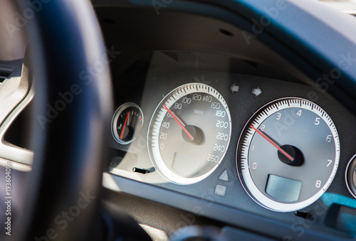 Front panel of car with speedometer and tachometer © Yuri Bizgaimer