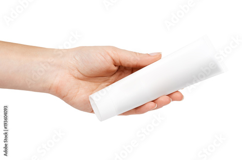 White cosmetic tube with cream in hand. Isolated on white background. Facial mask, lotion for body care, skin milk. Blank template