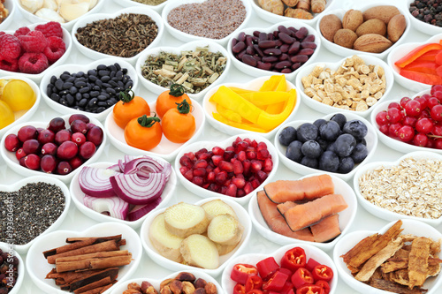 Super food nutrition for a healthy heart with fruit, vegetables, fish, cereals, seeds, nuts. spice and herbal medicine. Foods very high in antioxidants, omega 3, fibre, anthocyanins & vitamins.