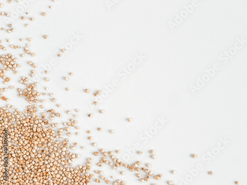 Grain of real quinoa isolated on white background. Uncooked raw quinoa as background. Healthy vegan food concept and pattern. Copy space. Top view or flat lay. Isolated one edge. © fascinadora