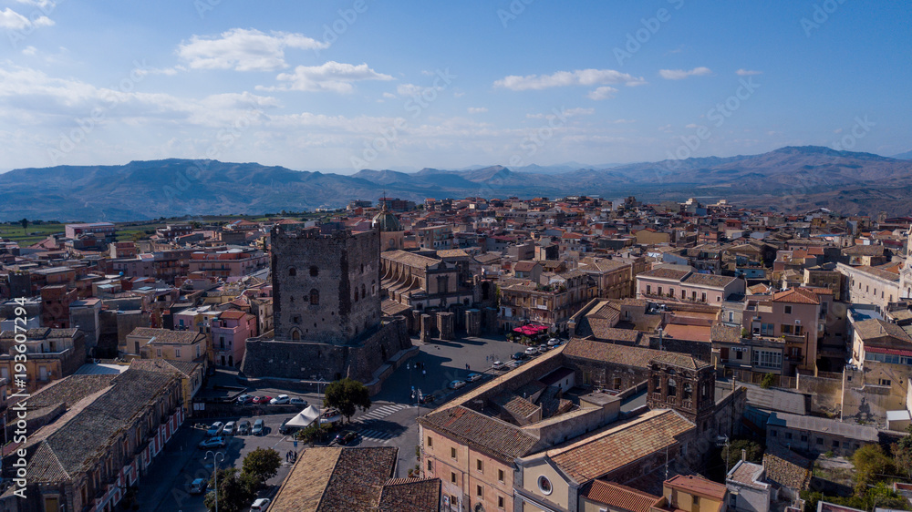 old castle in sicilian town from drone perspective aerial photo