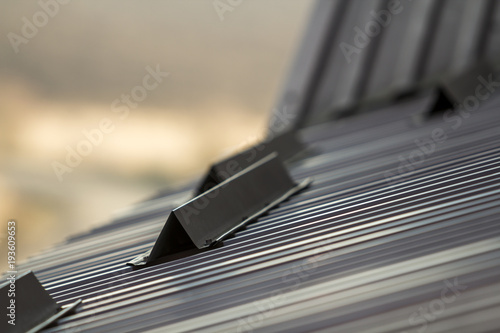 Foto Metal roof of a house close up with snow guards safety.