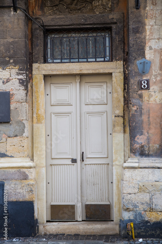 Beautiful beige yellow vintage doors in an old european city