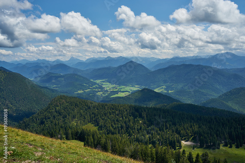 panoramic view at the bavarian alpes mountains with Jachenau under deep blue sky with white clouds