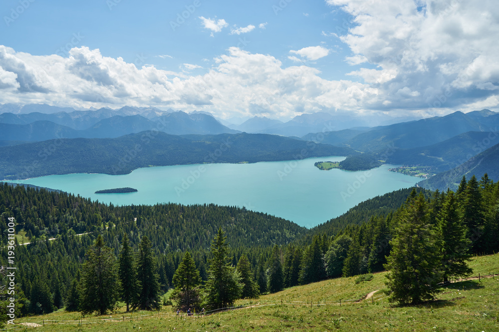 panoramic view at Walchensee in the bavarian alpes mountains with beautiful blue sky and white clouds