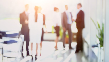 blurred image of business people standing in office.business bac