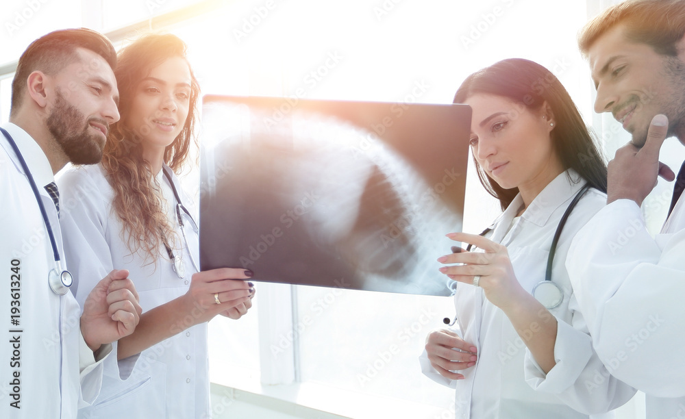 group of doctors discussing an x-ray. group of doctors discussing an x-ray.