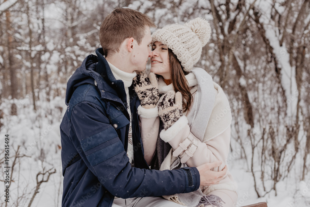 Happy Young Couple in Winter Park having fun.Family Outdoors. love Happy Young Couple in Winter Park having fun.Family Outdoors. love