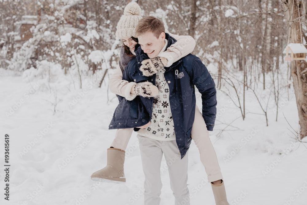 Happy Young Couple in Winter Park having fun.Family Outdoors. love Happy Young Couple in Winter Park having fun.Family Outdoors. love