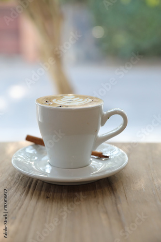 cappuccino or Latte art coffee made from milk on the wood table in coffee shop