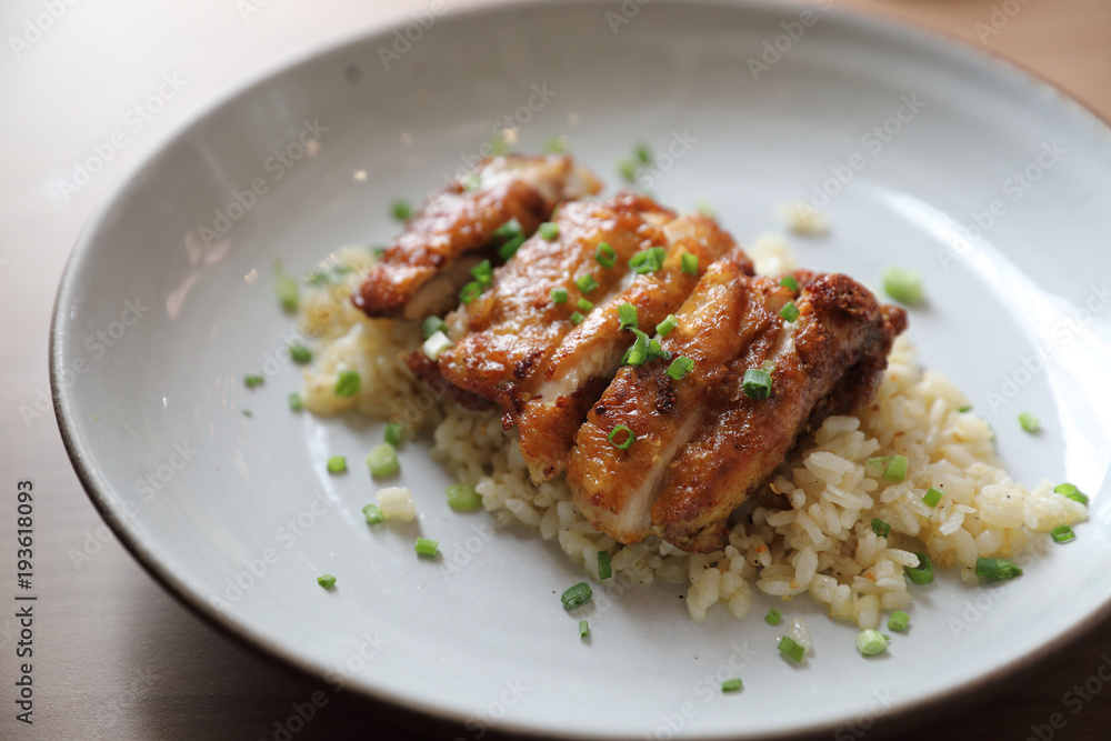 Nasi goreng fried rice with chicken on wood background