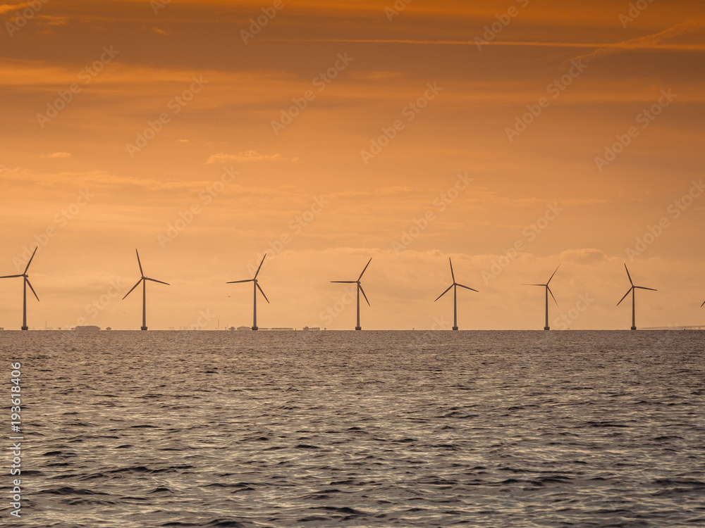 Wind turbines power generator farm along coast sea