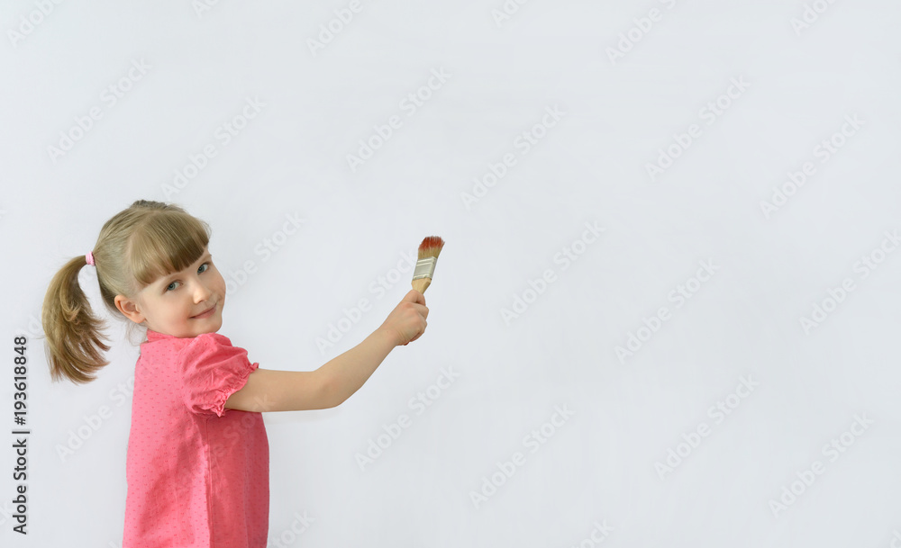 child, kid writes on the poster with a brush child, kid writes on the poster with a brush