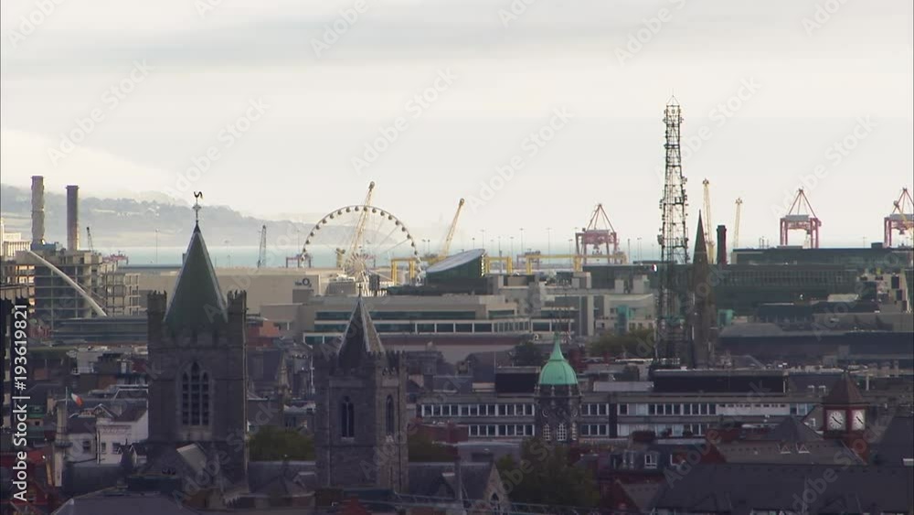 A steady shot of an urban place in Ireland. A big Ferris wheel is in the background. A steady shot of an urban place in Ireland. A big Ferris wheel is in the background.