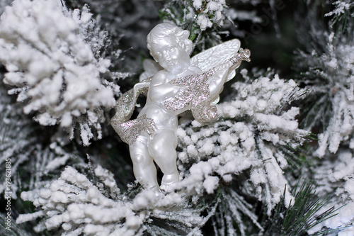 New Year's toys on snow-covered fir trees. Background. photo