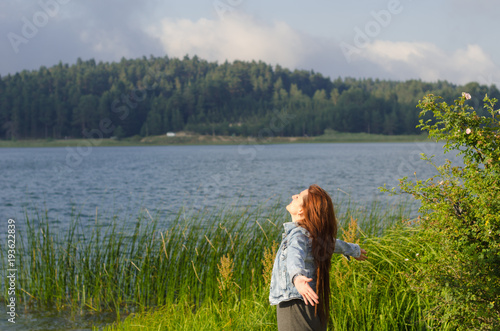 opened his arms on the lake shore, turned his face to the wind, a lonely young woman,