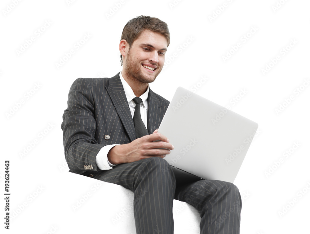 handsome young business man sitting on a white modern chair handsome young business man sitting on a white modern chair