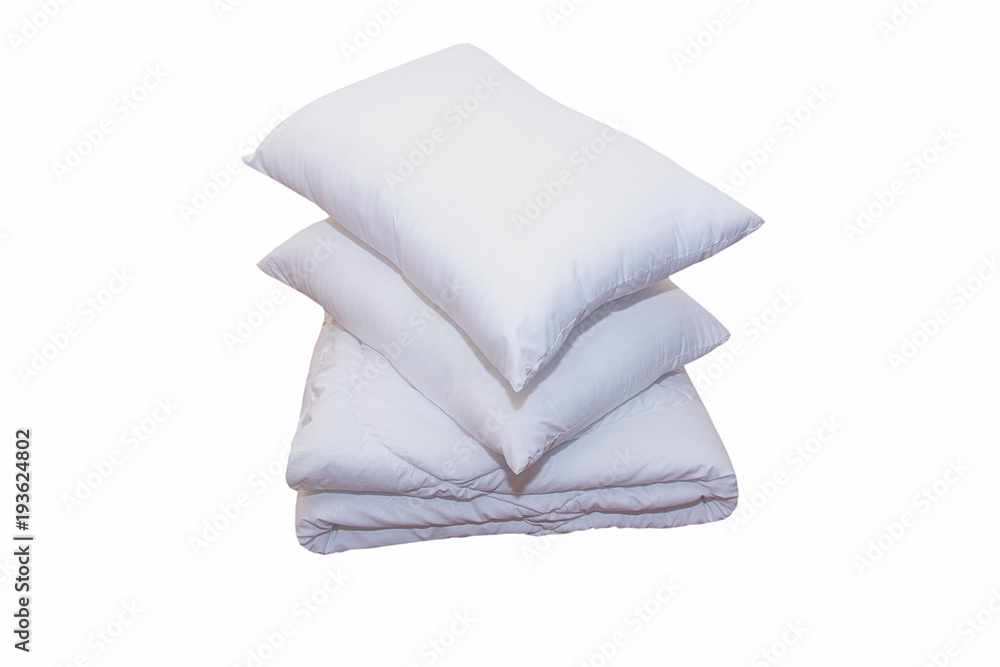 Roll of soft white blankets and white pillows isolated on white background Roll of soft white blankets and white pillows isolated on white background