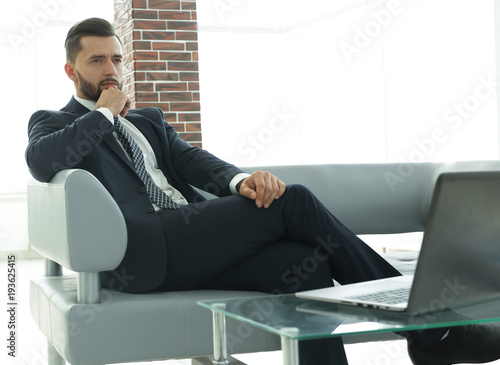 businessman sitting at a coffee table in the lobby