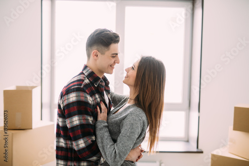 Young couple hug and kiss while moving to a new apartment together relocation © F8  \ Suport Ukraine