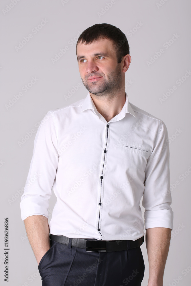 Confident young handsome man with hands in pockets, isolated on white background Confident young handsome man with hands in pockets, isolated on white background