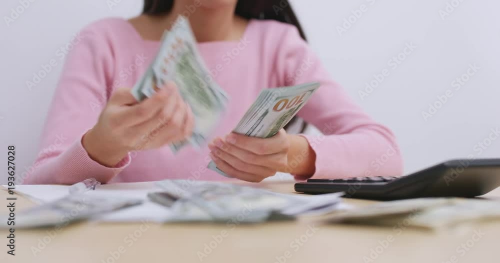 Woman counting the money for daily expenditure Woman counting the money for daily expenditure