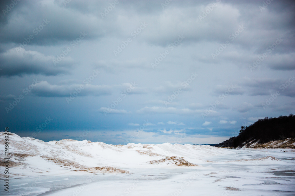 Sand dunes and frozen waves on cloudy day