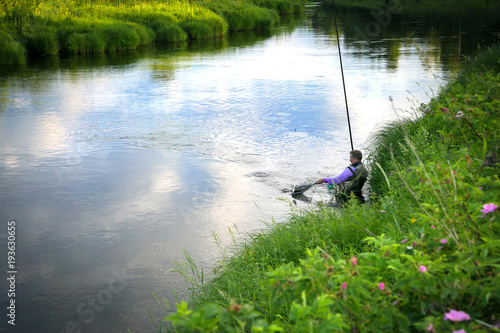 Fisherman caught fish on the river in the countryside.