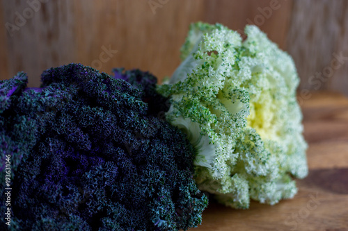 Decorative purple and white kale with wooden background