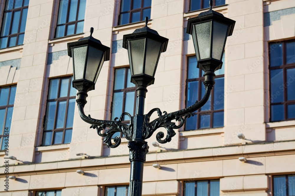 Street lamp (lantern) with forged metal elements in front of the building. Street lamp (lantern) with forged metal elements in front of the building.