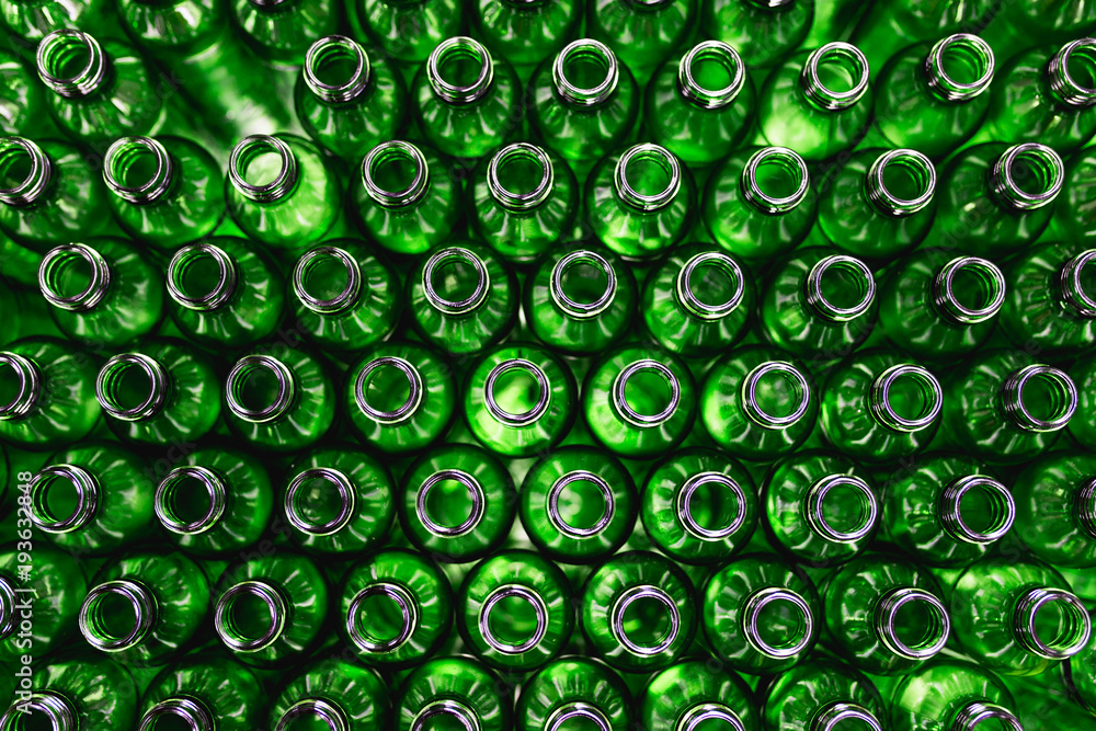 Bottling plant - Green glass bottles from above. Abstract background. Bottling plant - Green glass bottles from above. Abstract background.