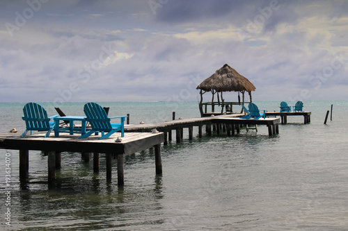 Relaxing Caribbean view from bright blue wooden loungers.