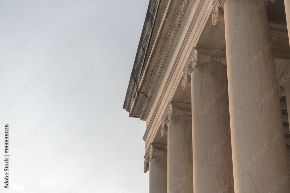 Outside columns of the Jefferson Monument in Washington, DC on a sunny day in the early morning. 